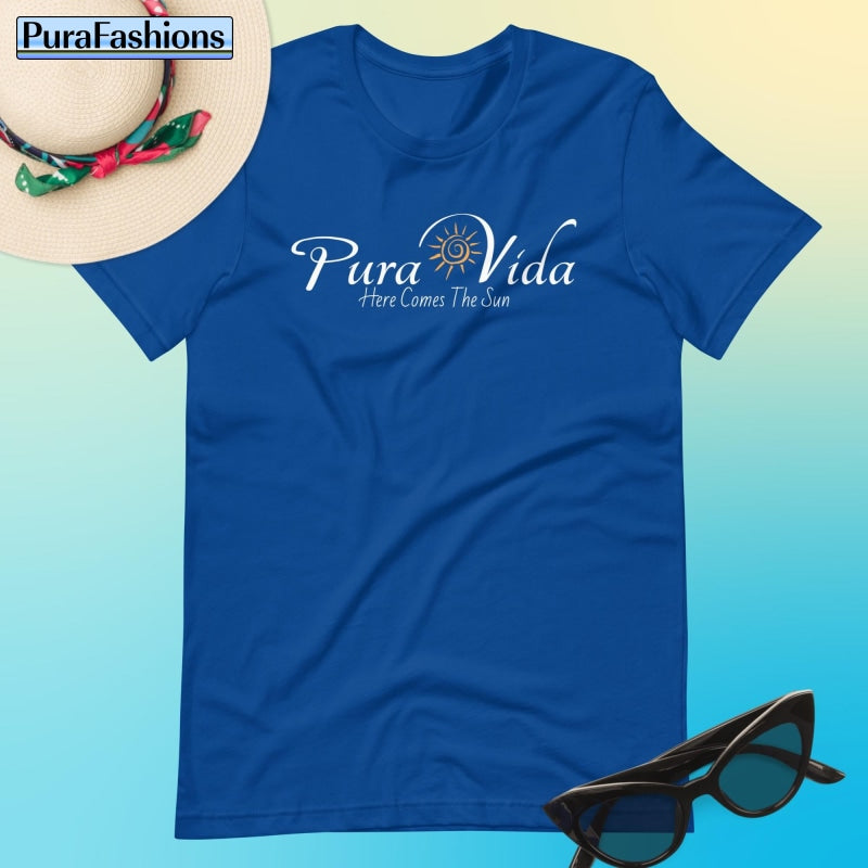 "Radiate positivity in our regal royal blue T-shirt, adorned with the inspiring message 'Pura Vida' and a vibrant sun graphic. Let the promise of sunshine accompany you wherever you go! Available now at PuraFashions.com."