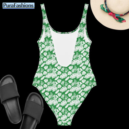 "Back view beauty: PuraFashions.com presents the reverse side of a one-piece swimsuit featuring a vibrant tropical leaves pattern on a serene sea green background, laid flat to showcase its striking design and coastal charm."