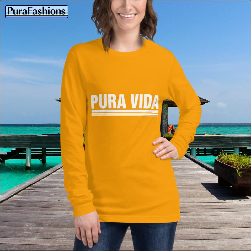 "Shine bright in this gold long sleeve tee featuring the uplifting message 'Pura Vida'. Add a touch of glamour to your wardrobe while spreading positivity. Get yours now at PuraFashions.com!"
