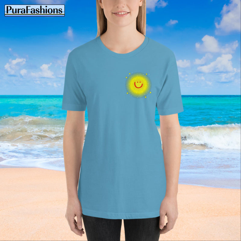 "Front view of a woman wearing an ocean blue T-shirt with a small happy face sun and a few stars on the chest. The T-shirt also features a large happy face sun, stars, and the text 'You're My Sunshine' on the back. Available at PuraFashions.com."