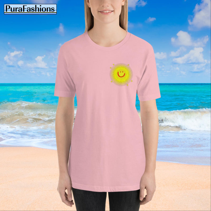 "Front view of a woman wearing an pink T-shirt with a small happy face sun and a few stars on the chest. The T-shirt also features a large happy face sun, stars, and the text 'You're My Sunshine' on the back. Available at PuraFashions.com."