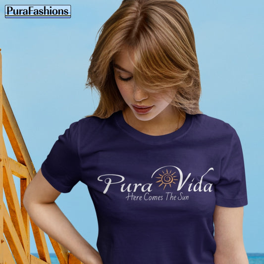 "Embrace the vibrant spirit of 'Pura Vida' with our radiant black T-shirt, adorned with a cheerful sun graphic. Let the warmth of our design ignite your day with positivity! Available now at PuraFashions.com."