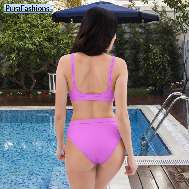 "Back view beauty: A woman stands by the poolside, revealing the charming back view of a pink high waist bikini from PuraFashions.com, exuding timeless elegance and feminine allure against the backdrop of the sparkling pool."