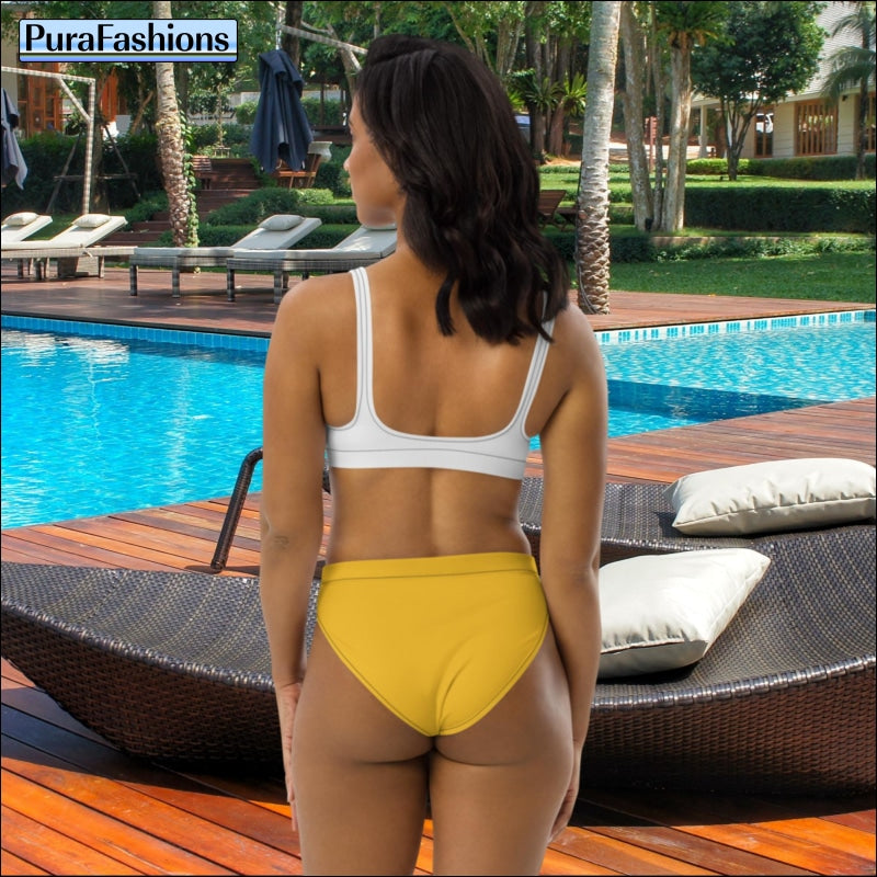 "Back view allure: Standing by the poolside, a woman showcases the captivating back view of a high waist bikini from PuraFashions.com, featuring a white top and sunny yellow bottoms, exuding timeless charm and vibrant style against the tranquil blue waters."