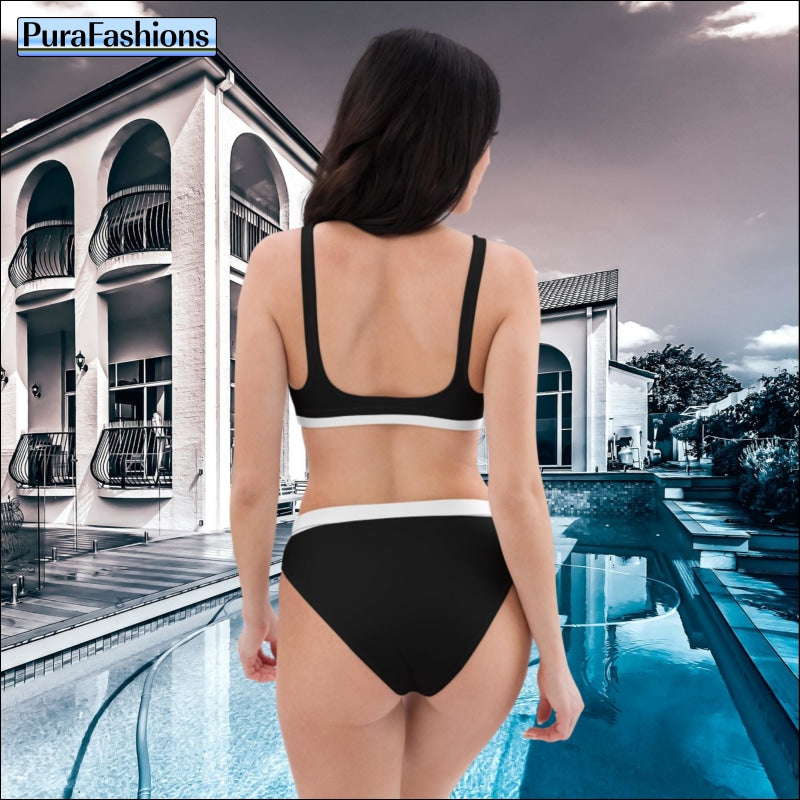 "Captured from the back, a woman stands elegantly by the poolside, flaunting a black high-waist bikini with stylish white trim, a classic ensemble from PuraFashions.com."