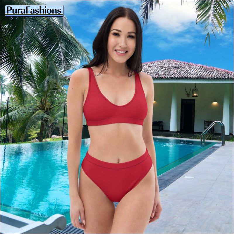 "Poolside elegance: A woman stands confidently in front of a gleaming swimming pool, showcasing a stunning red high waist bikini from PuraFashions.com, radiating timeless sophistication and vibrant style against the backdrop of the azure water."