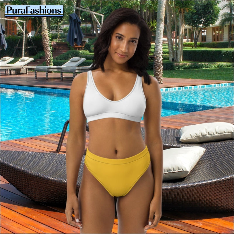 "Poolside chic: A woman stands gracefully by the swimming pool, wearing a stylish high waist bikini from PuraFashions.com featuring a white top and vibrant yellow bottoms, radiating summery charm and playful elegance against the backdrop of the sparkling pool."