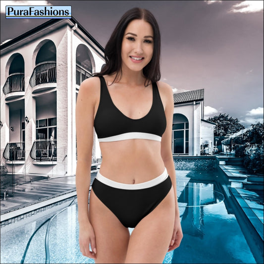 "Standing gracefully by the pool, a woman showcases a classic black high-waist bikini adorned with chic white trim, a timeless choice from PuraFashions.com."